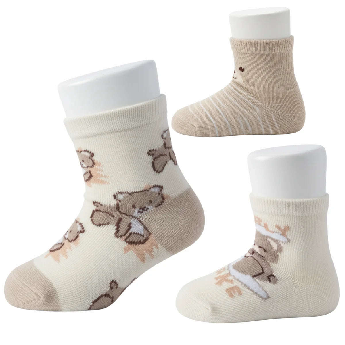 Three pairs of baby socks with bear designs on a white background
