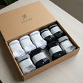 Box of white and black socks with 'Stride' branding on a light surface