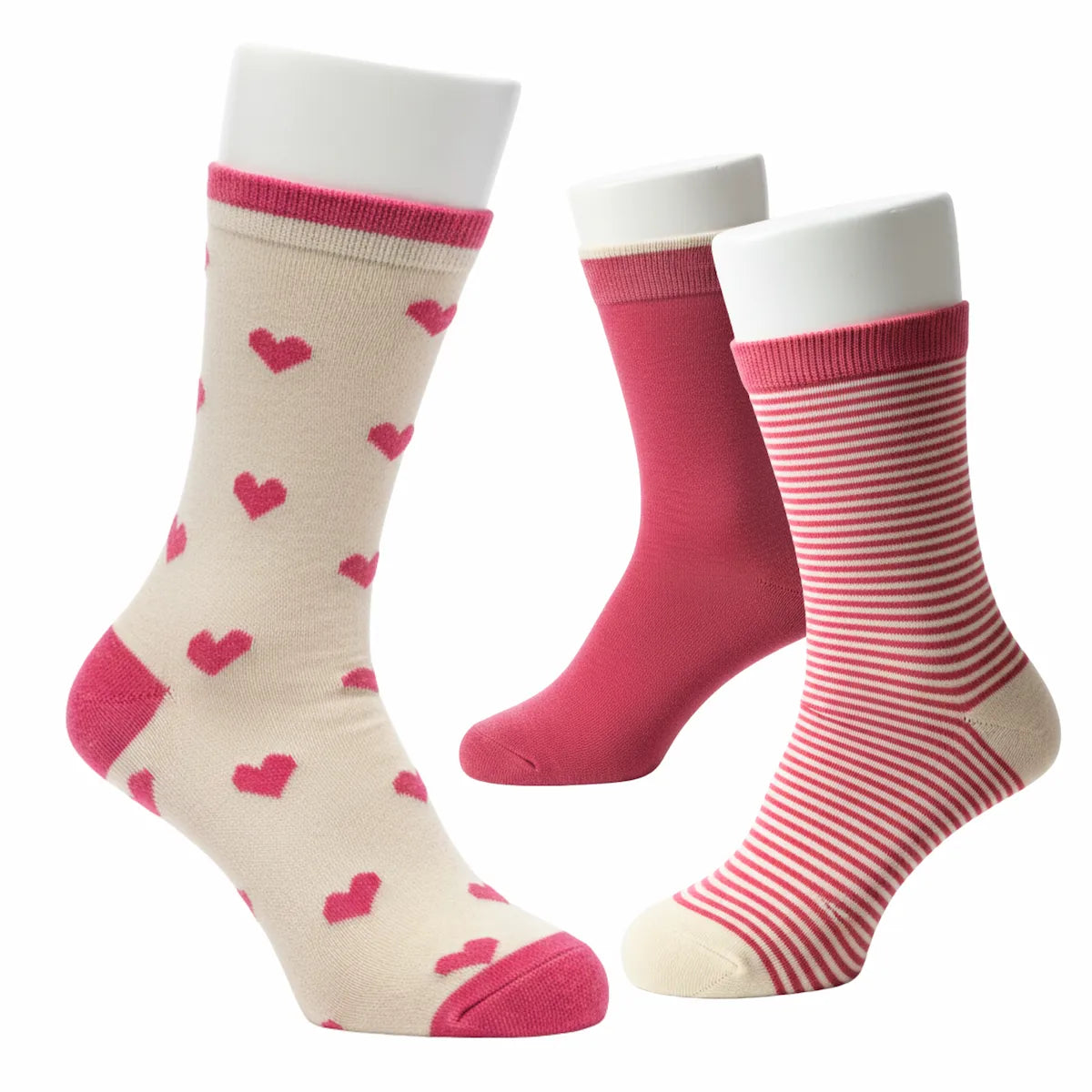 Set of three pairs of socks with heart patterns on a white background